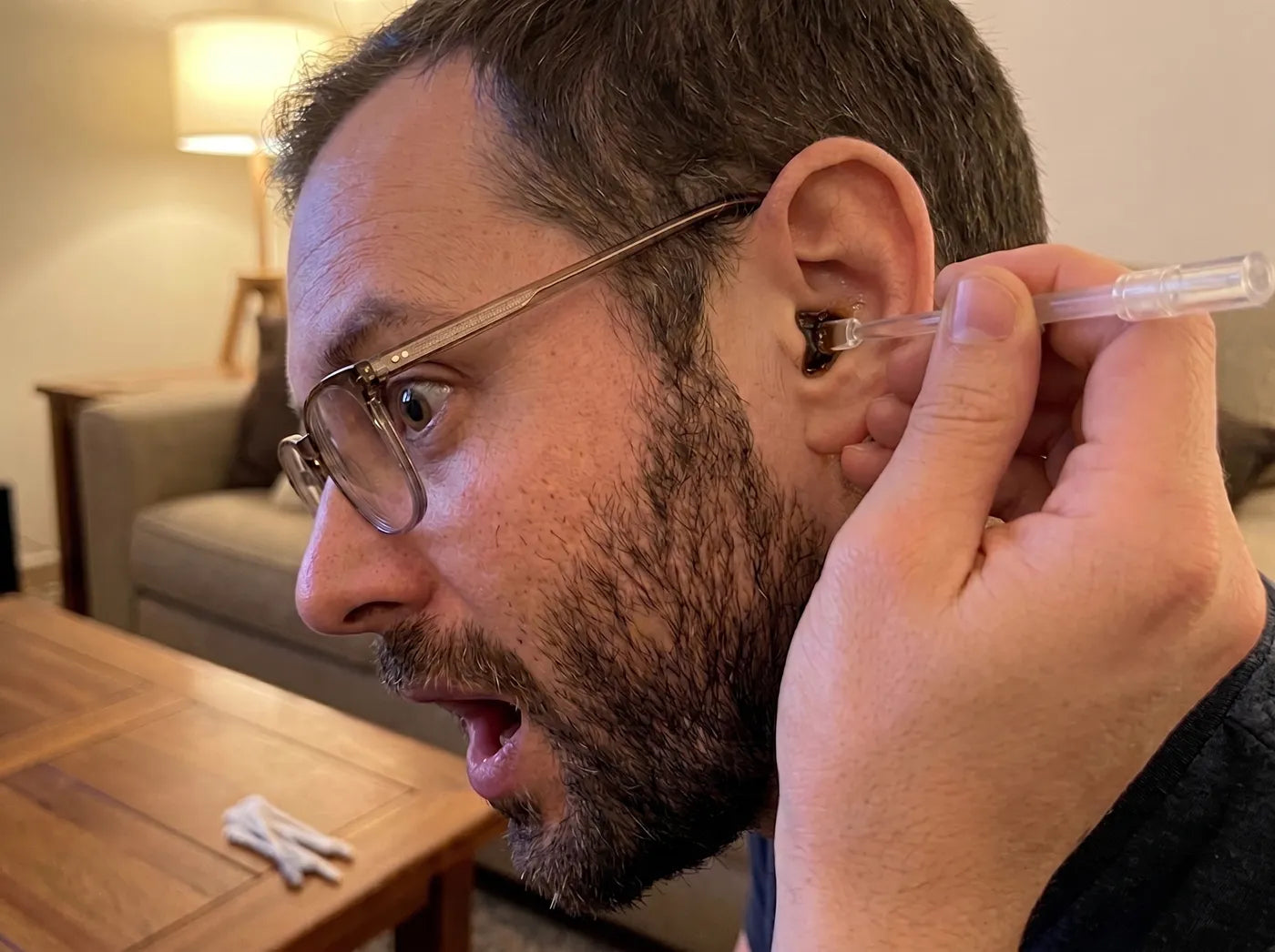 Man reacting while using the Earclear sticky ear cleaner