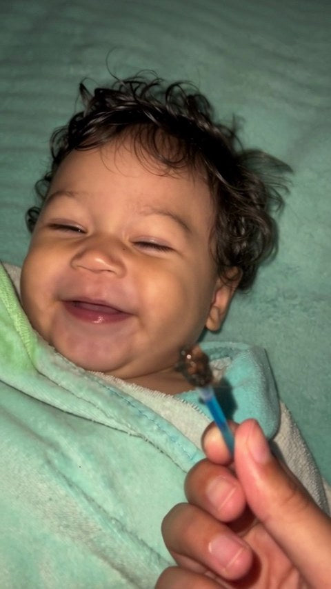 Toddler giggling during ear cleaning